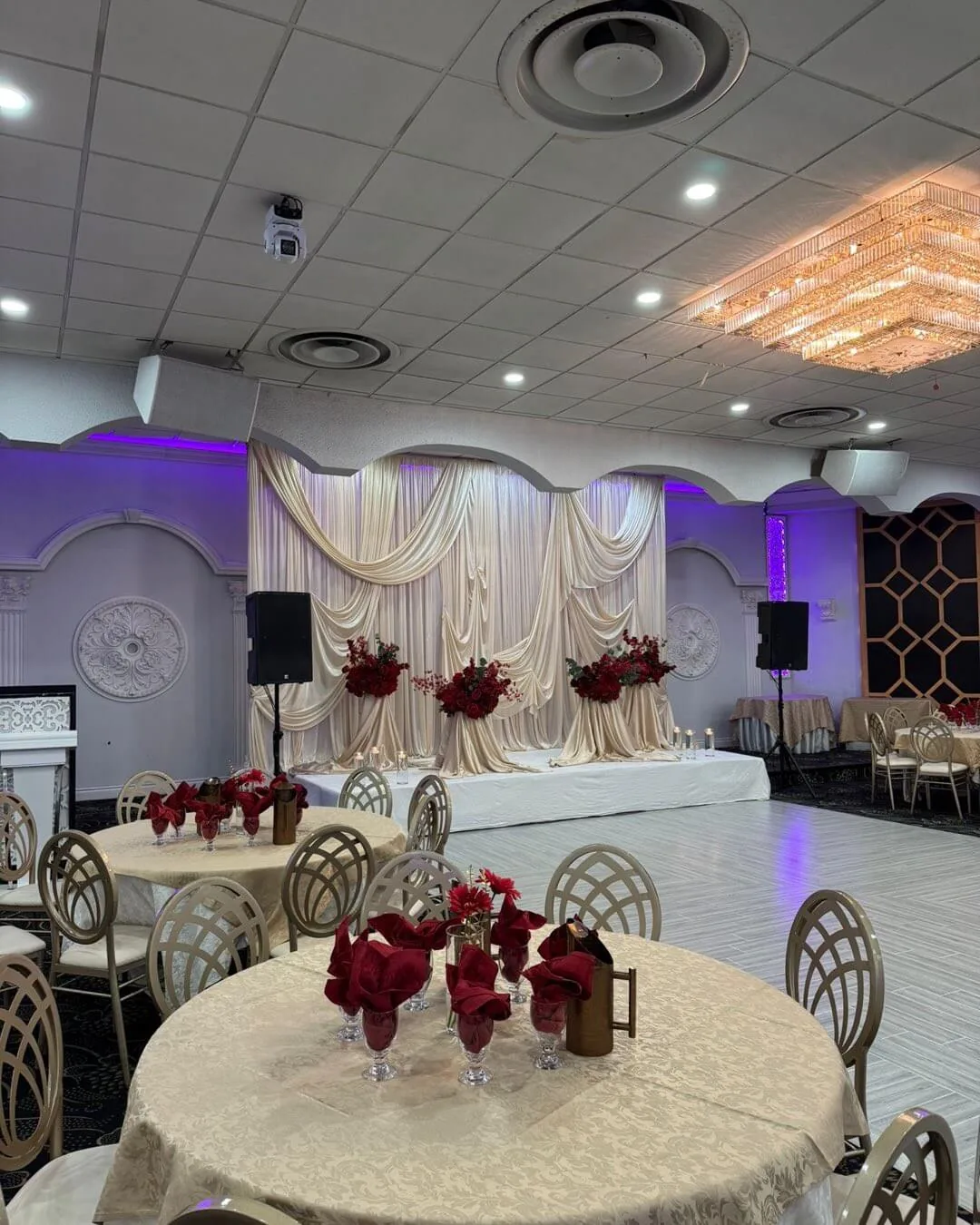 Tall floral centrepiece on a linen-covered banquet table.